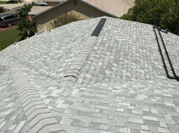 A completed light-colored shingle roof viewed from above