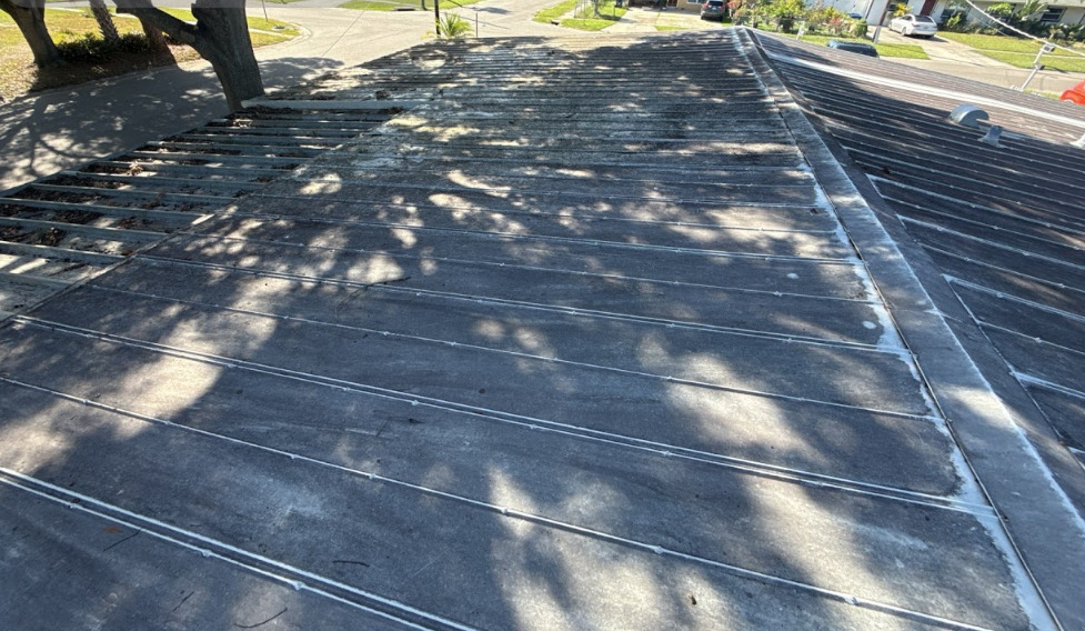 A low-slope roof deck during roofing work