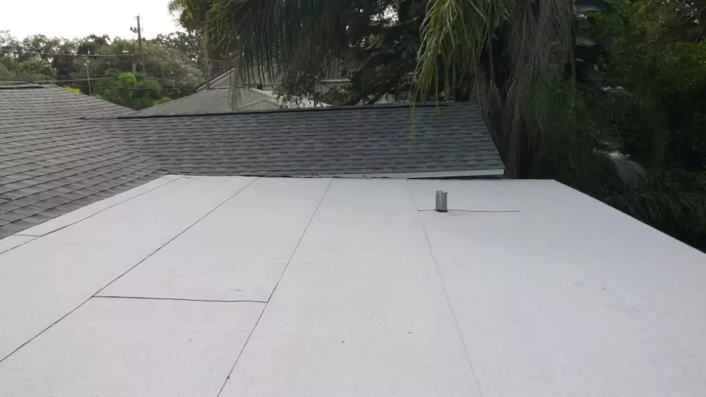 A flat roof alongside a shingle roof